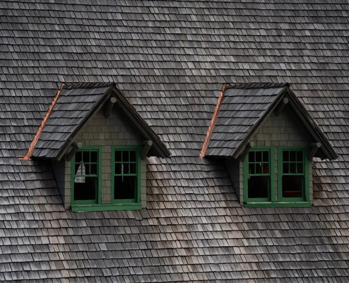 Dormers on a shingle roof in Bismarck, ND, where step flashing and kickout flashing carry water past the walls